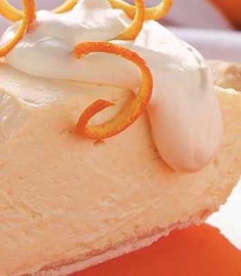 Yogurt, lower-fat cream cheese and orange juice concentrate make this Rich and Creamy Orange Cheesecake Pie light and refreshing.