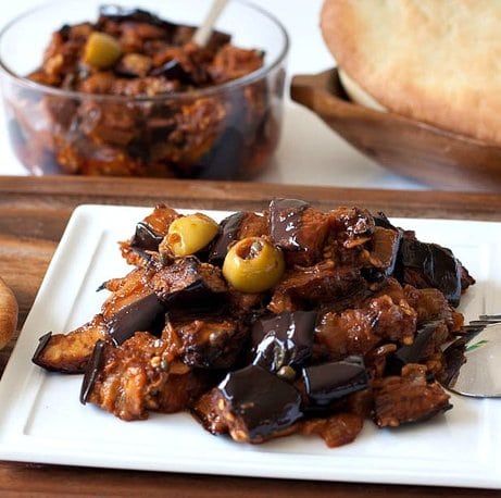 Caponata is a Sicilian eggplant dish consisting of a cooked vegetable salad made from chopped fried eggplant and celery seasoned with sweetened vinegar, with capers in a sweet and sour sauce.