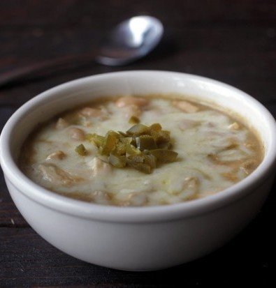 At Lewis and Clark's, the white chili is not terribly spicy and not too thick. They serve it with a small portion of sour cream, jalapeños and crackers on the side.