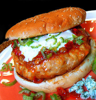 Recipe for Fiery Buffalo Chicken Burgers - Charge up your chicken burgers with a serious dose of hot sauce, cooled off with a dose of ranch dip to top.