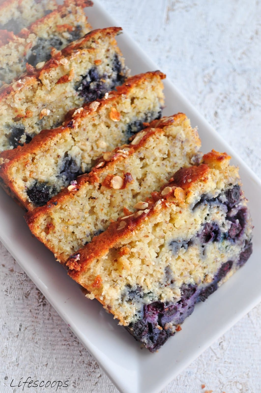 This Lemon Blueberry Oatmeal Bread is really moist with oodles of succulent blueberries in it and the texture is sort of a hybrid between that of a cake and a bread.