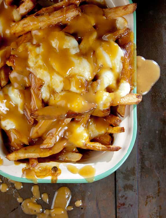 Recipe for Poutine - French Fries with Gravy and Cheese Curds - An unabashedly savory collage of french-fried potatoes, beef gravy, and squeaky-fresh cheese curds, poutine is perhaps the ultimate late-night snack.