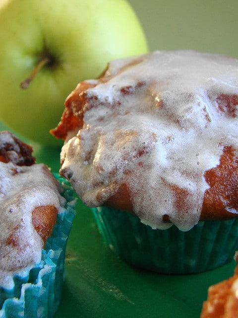 Baked cinnamon fritter batter with Pippin Apples....fried and glazed with cinnamon drizzle. These Apple Fritter Cupcakes melt in your mouth!