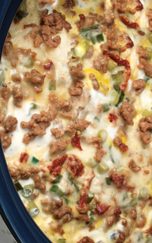 A Slow Cooker Breakfast Casserole filled with sausage, potatoes, eggs and cheese – all your favorites. This is a wonderful recipe that can cook all night while you sleep. Wake up, make the coffee, and breakfast is ready.
