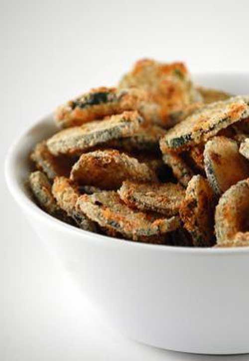 Baked Zucchini Chips - Ditch the potato chips and reach for these healthier baked zucchini chips instead! They'll still satisfy that salty and crunchy flavor, but without all the added fat and calories