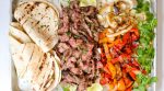 All it takes is a simple marinade and a screaming hot grill to put together this amazing platter of steak fajitas.
