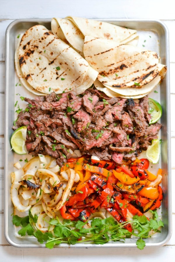 All it takes is a simple marinade and a screaming hot grill to put together this amazing platter of skirt steak fajitas.