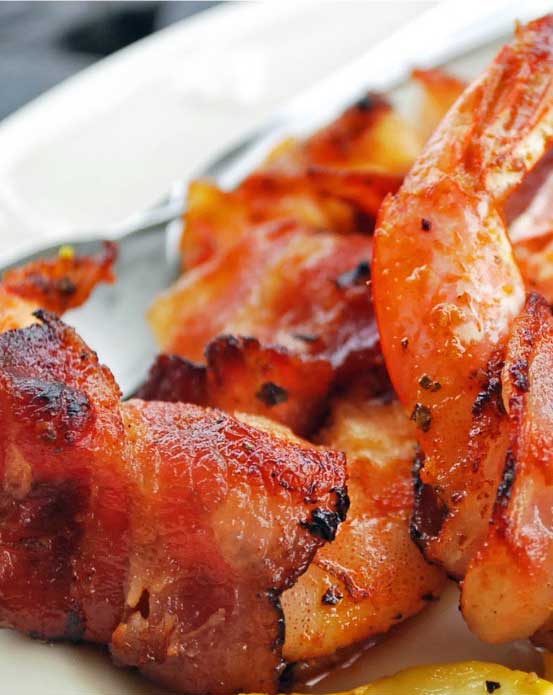 A tasty appetizer of Bacon-Wrapped Shrimp will be hit with your party crowd.