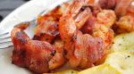 A tasty appetizer of Bacon-Wrapped Shrimp will be hit with your party crowd.