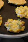 These corn and roasted green chile fritters are a versatile dish. Cook up a batch of these fritters for breakfast and serve with a fried egg or go the lunch route and top the fritters with sour green and some shredded beef.