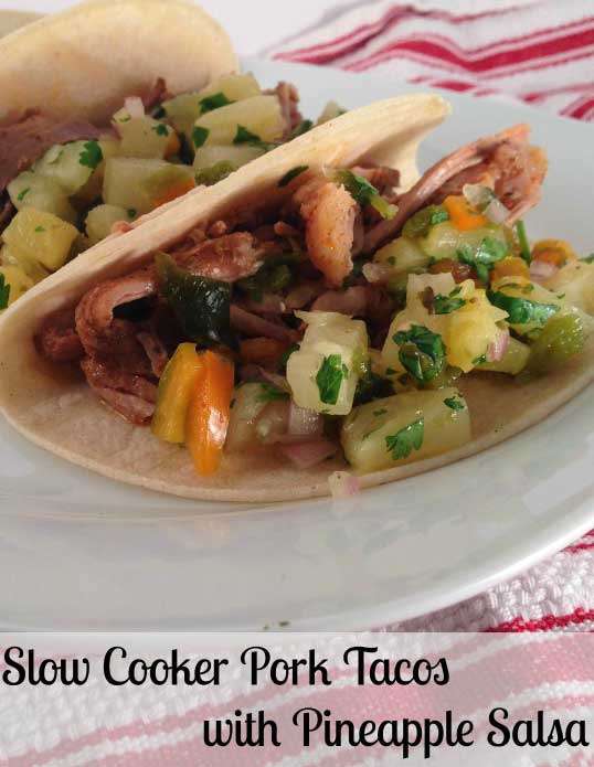Recipe for Slow Cooker Pork Tacos with Pineapple Salsa - A little bit messy, a whole lot delicious! These Slow Cooker Pork Tacos with Pineapple Salsa are easy to make and have such incredible flavor.