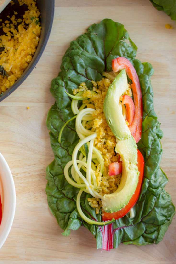 Swiss Chard Wraps - Simple, colorful swiss chard wraps filled with zucchini noodles, crisp red bell peppers, sautéed yellow cauliflower, and creamy slices of avocado.