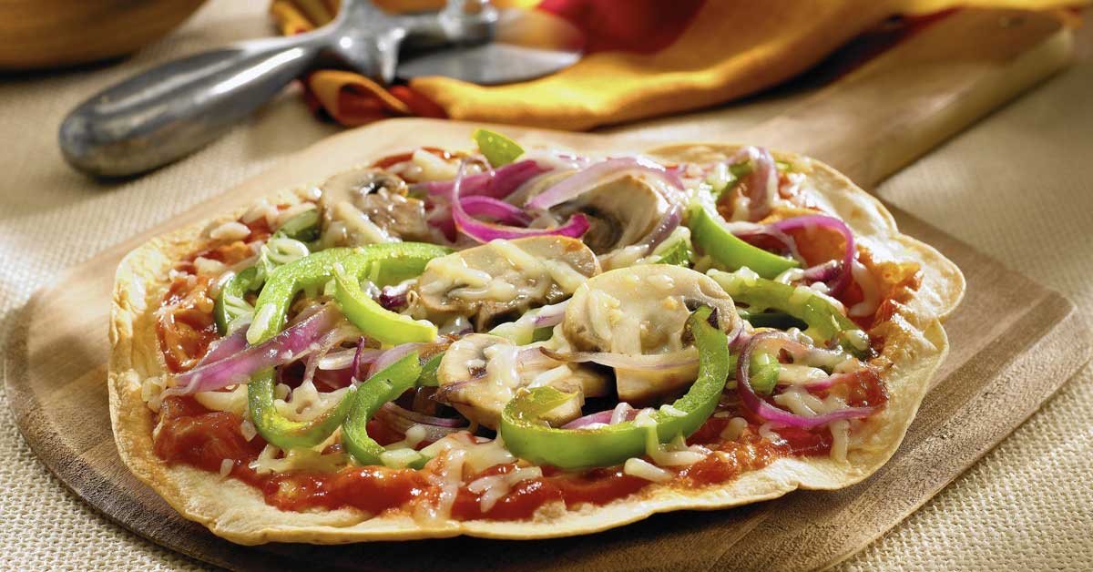 Next time they ask for pizza, you can feel good about saying "yes!", with this Skinny Pizza recipe. Flour tortillas make for a crispy crust, perfect for loading with tomato sauce, cheese, and lots of fresh veggies.